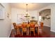 Elegant dining room with hardwood floors, a chandelier, and ample seating for Gathering and guests at 8835 Abbey Leaf Ln, Orlando, FL 32827