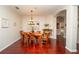 Formal dining area with hardwood flooring, stylish lighting, and a view of adjacent rooms at 8835 Abbey Leaf Ln, Orlando, FL 32827