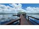 Scenic view of a lake featuring a dock gazebo with covered seating and calming waters at 8835 Abbey Leaf Ln, Orlando, FL 32827