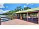 Spacious wooden gazebo on a dock with bench seating and lake views at 8835 Abbey Leaf Ln, Orlando, FL 32827