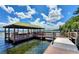 Dock gazebo with picnic table and bench seating overlooking a peaceful lake at 8835 Abbey Leaf Ln, Orlando, FL 32827