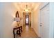 Inviting hallway with tile flooring, decorative lighting, and a red front door with decorative wreath at 8835 Abbey Leaf Ln, Orlando, FL 32827