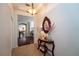Bright hallway features tile flooring, a decorative mirror, and a glimpse into the living spaces at 8835 Abbey Leaf Ln, Orlando, FL 32827