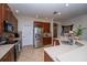 Spacious kitchen with stainless steel appliances and tile flooring at 8835 Abbey Leaf Ln, Orlando, FL 32827