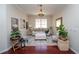 Bright living room with neutral tones, modern decor, and rich hardwood flooring at 8835 Abbey Leaf Ln, Orlando, FL 32827