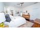 Main bedroom with a ceiling fan, ensuite bath, and light colored walls at 8835 Abbey Leaf Ln, Orlando, FL 32827