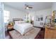 Main bedroom with a ceiling fan, ensuite bath, and light colored walls at 8835 Abbey Leaf Ln, Orlando, FL 32827
