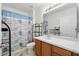 Clean bathroom with wood cabinets, a shower with beach themed curtain, and tiled floors at 1231 Wright Cir # 1213, Celebration, FL 34747