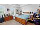 Bedroom with a wood bed frame, dresser, and natural light from a window at 1231 Wright Cir # 1213, Celebration, FL 34747