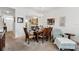 Carpeted dining room with a wooden table, chandelier, and open view to the kitchen at 1231 Wright Cir # 1213, Celebration, FL 34747