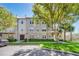 Condo building featuring well-maintained landscaping, trees, and assigned parking at 1231 Wright Cir # 1213, Celebration, FL 34747