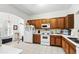 Bright kitchen with tile flooring, white appliances, and wood cabinetry at 1231 Wright Cir # 1213, Celebration, FL 34747