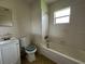 Bathroom with a vanity, toilet, and tiled bathtub and shower combo at 127 Alabama Ave, St Cloud, FL 34769