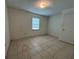 Bedroom featuring tiled floors, a window, and a closet at 127 Alabama Ave, St Cloud, FL 34769