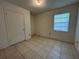 Bedroom featuring tiled floors, a window, and a closet at 127 Alabama Ave, St Cloud, FL 34769