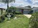 Charming single-story home with a red front door and a lush, landscaped front yard at 127 Alabama Ave, St Cloud, FL 34769