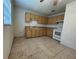 Kitchen featuring wooden cabinets, an electric range, and tiled floors at 127 Alabama Ave, St Cloud, FL 34769