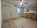 Kitchenette with tiled floors, ample cabinet space, and a window at 127 Alabama Ave, St Cloud, FL 34769