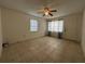 Bright living room featuring tiled floors, a ceiling fan, and a window with blinds at 127 Alabama Ave, St Cloud, FL 34769