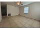 Living room with tiled floors, a ceiling fan, and natural light from a window at 127 Alabama Ave, St Cloud, FL 34769