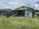 View of the rear exterior of the home showing the backyard and the home's back entrance at 127 Alabama Ave, St Cloud, FL 34769