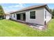 Spacious backyard with potential for outdoor entertaining, featuring a covered patio and ample green space at 1394 Palmetto Dunes St, Champions Gate, FL 33896