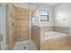 Bathroom featuring a tiled walk-in shower and garden tub at 1394 Palmetto Dunes St, Champions Gate, FL 33896