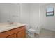 Bathroom with single sink vanity, toilet, and tub/shower combo with bright light at 1394 Palmetto Dunes St, Champions Gate, FL 33896
