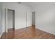 Neutral bedroom features wood-look floors, closet, and white walls at 1394 Palmetto Dunes St, Champions Gate, FL 33896