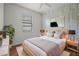 Cozy bedroom with a comfortable bed, accent wall, and natural light from the window at 1394 Palmetto Dunes St, Champions Gate, FL 33896