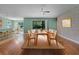 Spacious dining room featuring a wooden table, seating for six, and access to the backyard at 1394 Palmetto Dunes St, Champions Gate, FL 33896