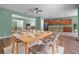 Open dining area featuring a wooden table, seating for six, and views into the kitchen at 1394 Palmetto Dunes St, Champions Gate, FL 33896