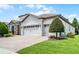 Charming home features manicured lawn, brick driveway, and a three car garage at 1394 Palmetto Dunes St, Champions Gate, FL 33896