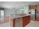 Open kitchen with stainless steel dishwasher and a breakfast bar at 1394 Palmetto Dunes St, Champions Gate, FL 33896