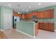 Bright kitchen with stainless steel appliances, wood cabinets, and granite countertops at 1394 Palmetto Dunes St, Champions Gate, FL 33896