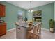 Kitchen island featuring a gray countertop, seating for four, and decorative pendant lighting at 1394 Palmetto Dunes St, Champions Gate, FL 33896