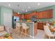 Well-equipped kitchen with stainless steel appliances, a breakfast bar, and wooden cabinets at 1394 Palmetto Dunes St, Champions Gate, FL 33896
