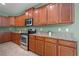 Gourmet kitchen with stainless steel appliances and lots of wood cabinets at 1394 Palmetto Dunes St, Champions Gate, FL 33896