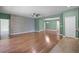 Bright living room boasts wood floors, designer accent wall, neutral paint, and ceiling fan at 1394 Palmetto Dunes St, Champions Gate, FL 33896