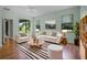 Bright living room with a sliding glass door, neutral decor, and views of the backyard at 1394 Palmetto Dunes St, Champions Gate, FL 33896