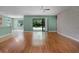 Open living area with laminate wood flooring and access to the back yard at 1394 Palmetto Dunes St, Champions Gate, FL 33896
