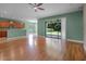 Open living area with laminate wood flooring and sliding glass doors to the back yard at 1394 Palmetto Dunes St, Champions Gate, FL 33896