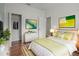 Airy bedroom showcasing wood floors, closet, and stylish, minimalist decor at 1394 Palmetto Dunes St, Champions Gate, FL 33896