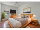 Relaxing bedroom features neutral colors, wood floors, ceiling fan and stylish furnishings at 1394 Palmetto Dunes St, Champions Gate, FL 33896