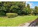 Lush yard featuring mature trees and manicured landscaping, creating a private and serene outdoor space at 1394 Palmetto Dunes St, Champions Gate, FL 33896