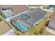 An aerial view showcasing the screened pool, landscaped yard, and the home's layout within the neighborhood at 142 Ethan Ave, Davenport, FL 33897