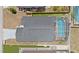 A top-down aerial view showing the home's roof, driveway, surrounding landscaping, and screened pool area at 142 Ethan Ave, Davenport, FL 33897