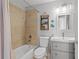 Bathroom featuring tub, neutral tile, and modern vanity at 142 Ethan Ave, Davenport, FL 33897