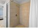 Walk-in shower with modern tile work, door to bedroom, and modern fixtures at 142 Ethan Ave, Davenport, FL 33897
