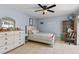 Cozy bedroom with soft blue walls, neutral-toned furniture, and an accent ceiling fan at 142 Ethan Ave, Davenport, FL 33897